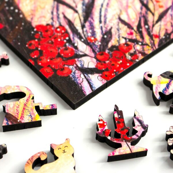 happy winter wooden jigsaw puzzle showing a corner of the puzzle and some whimsy pieces shaped like a candle